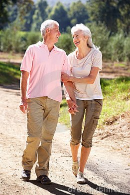 senior-couple-walking-country-21235370
